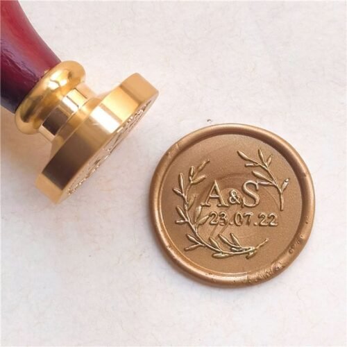 Personalised wax seal featuring initials and olive branches